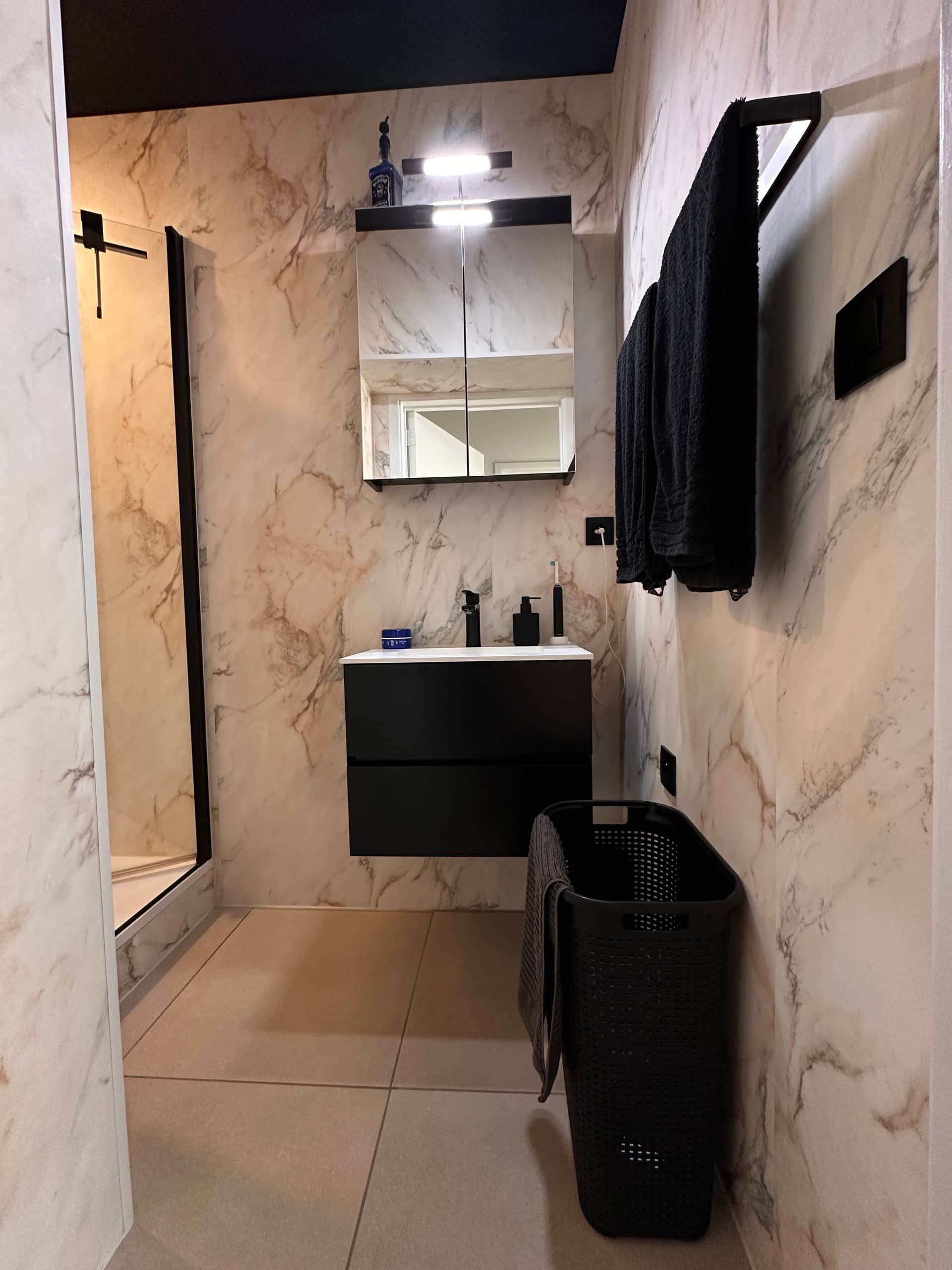 Bathroom with washbasin and mirror cabinet