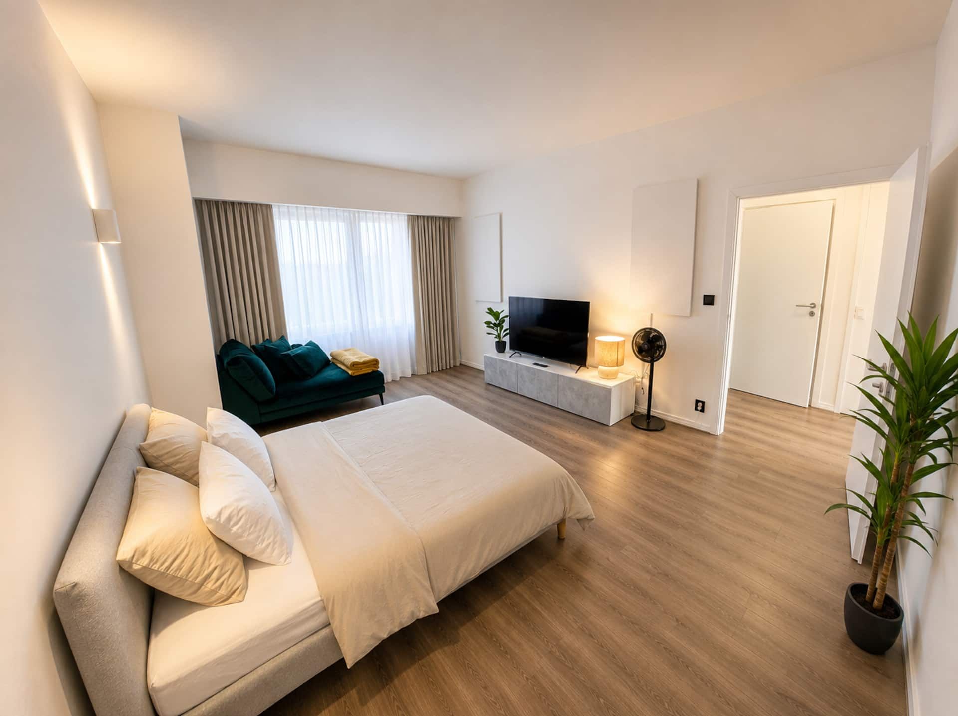 Bedroom with a double bed, sofa and TV