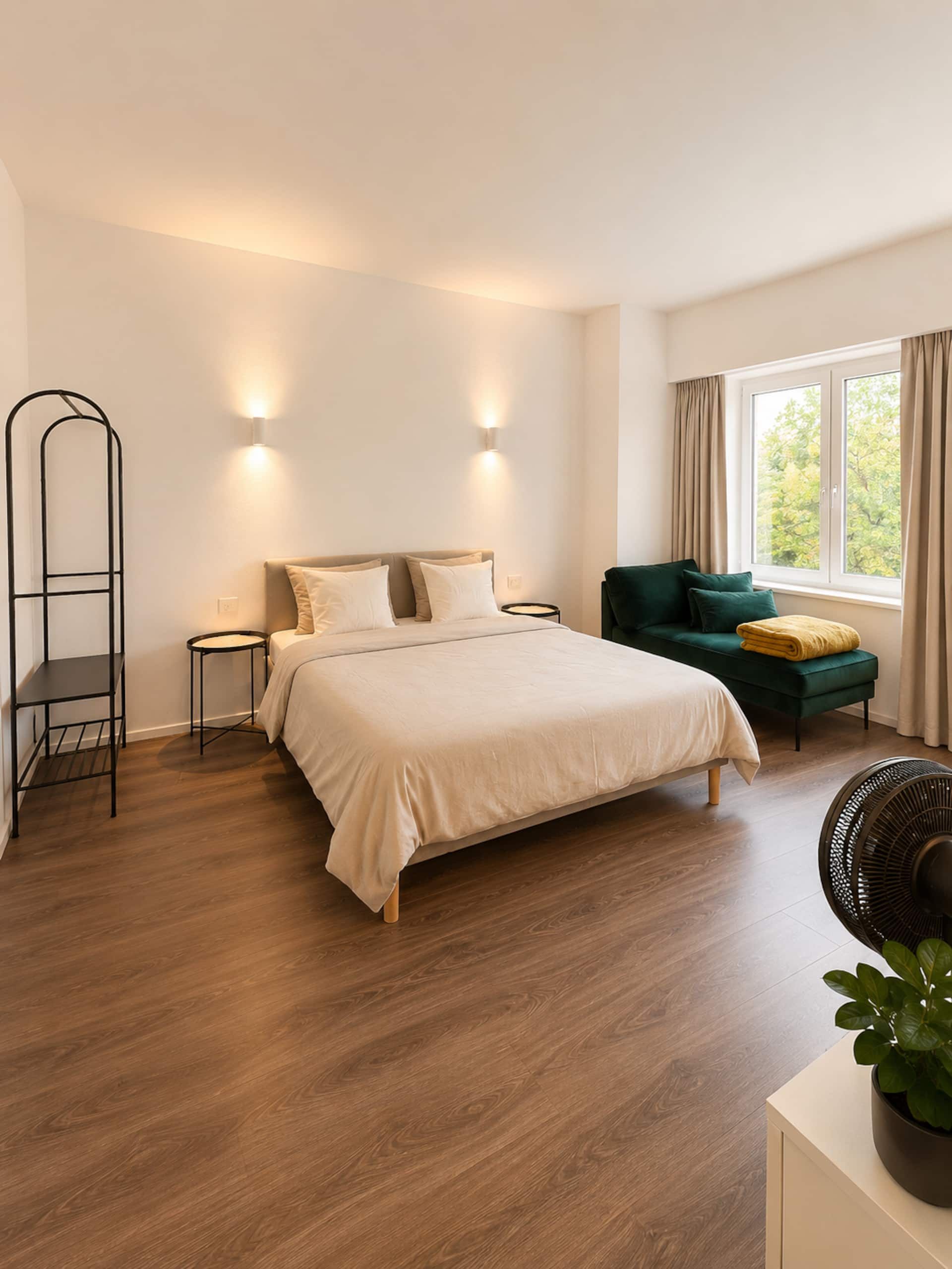 Bedroom with a double bed and an armchair