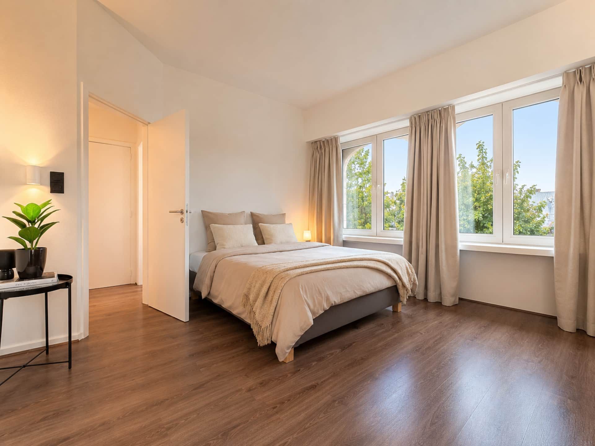 Bedroom with a double bed and large windows