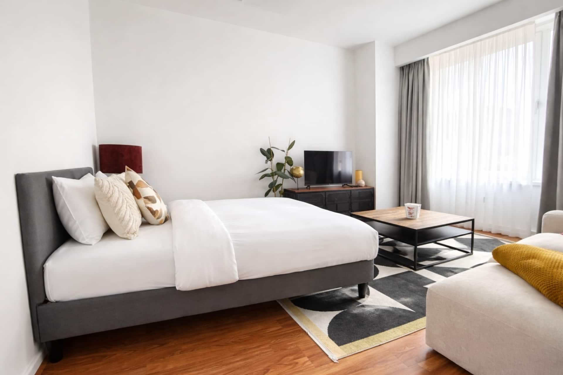 Bedroom with a double bed, sofa and TV